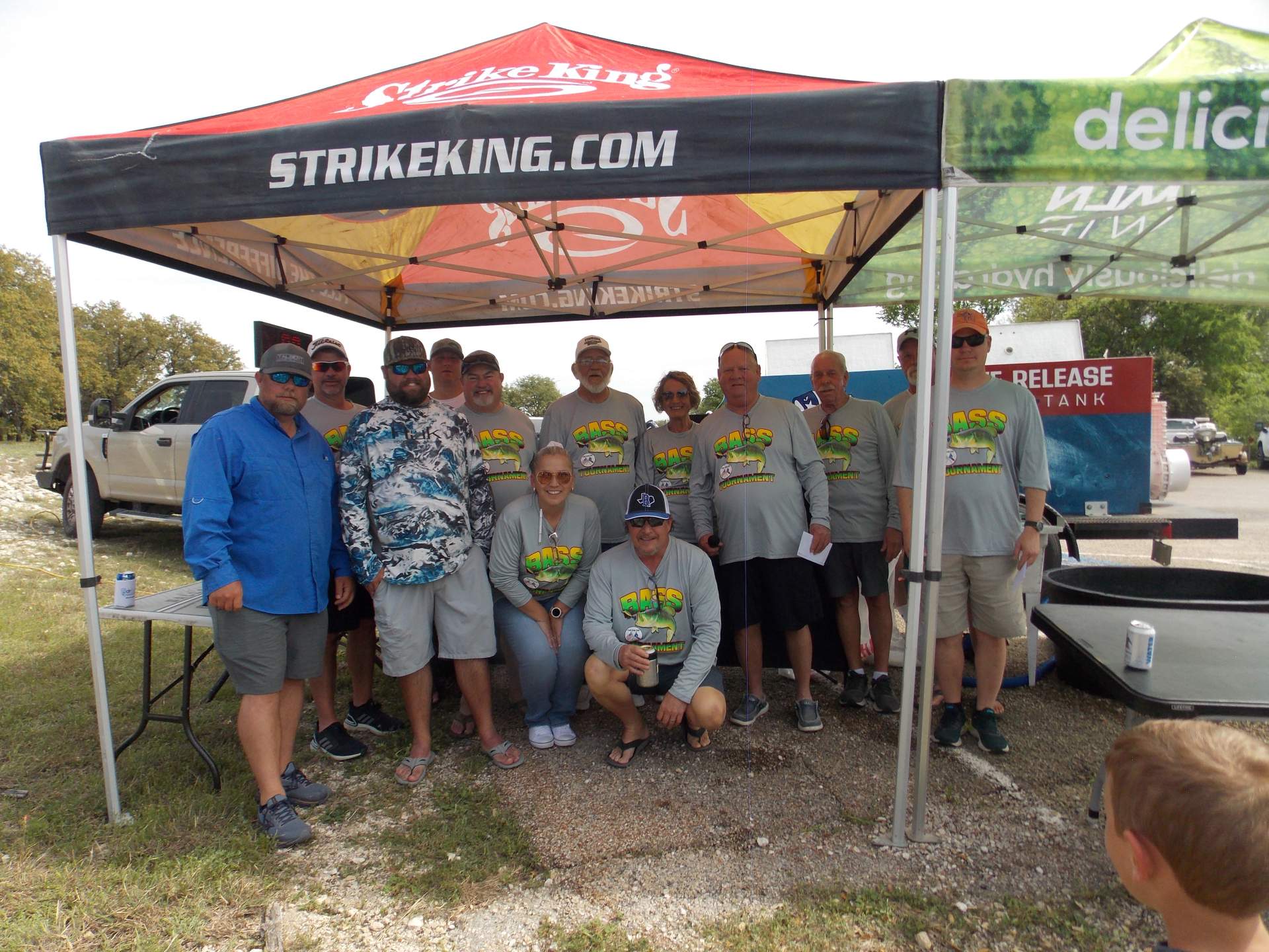 A group of fisherman standing under a canopy